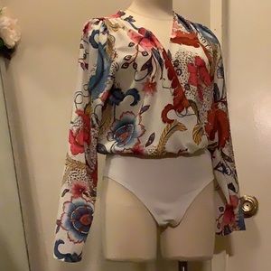 A colorful long sleeve body suit.